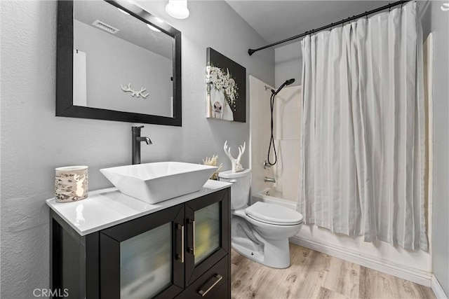 full bath with vanity, wood finished floors, visible vents, shower / bath combination with curtain, and toilet