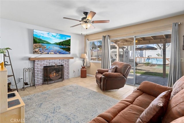 tiled living room featuring a fireplace, baseboards, and a ceiling fan