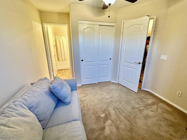 interior space with carpet flooring, a ceiling fan, and baseboards