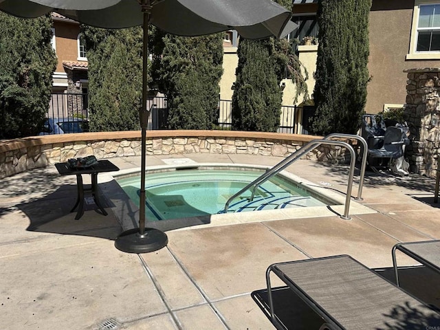 view of pool with a patio area, a hot tub, and fence