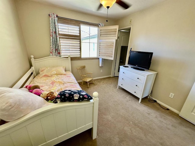 carpeted bedroom with baseboards and a ceiling fan