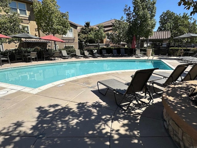 pool featuring a patio and fence