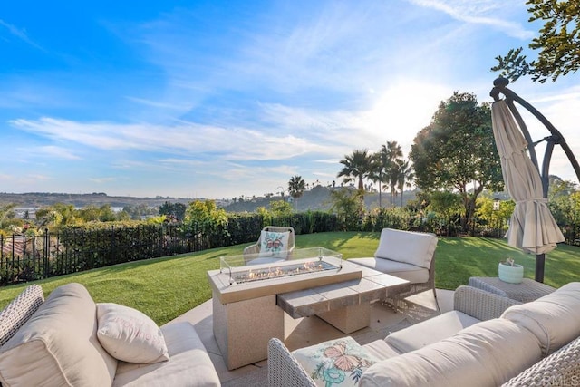 view of patio / terrace with an outdoor living space with a fire pit and a fenced backyard