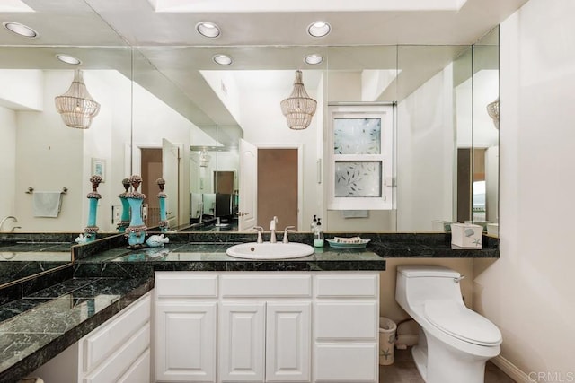 bathroom with recessed lighting, vanity, and toilet