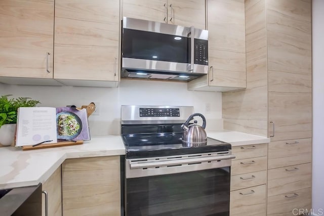 4197 Tiberon Dr, Oceanside, CA 92056 - kitchen featuring light brown cabinets, appliances with stainless steel finishes, modern cabinets, and light countertops