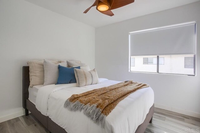 4197 Tiberon Dr, Oceanside, CA 92056 - bedroom featuring baseboards, wood finished floors, and a ceiling fan