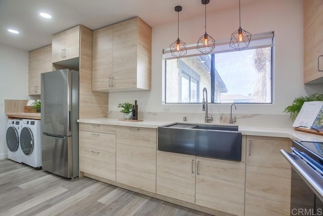 4197 Tiberon Dr, Oceanside, CA 92056 - kitchen with a sink, appliances with stainless steel finishes, light brown cabinetry, and washing machine and clothes dryer