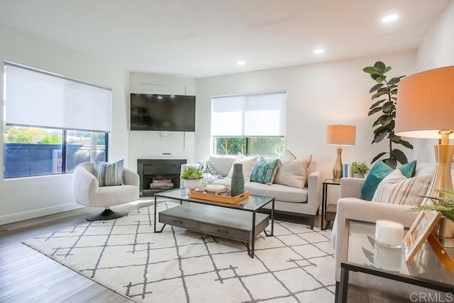4197 Tiberon Dr, Oceanside, CA 92056 - living room with a glass covered fireplace, recessed lighting, light wood-style floors, and a wealth of natural light