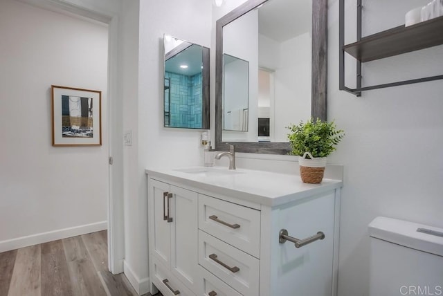 4197 Tiberon Dr, Oceanside, CA 92056 - bathroom featuring toilet, vanity, baseboards, and wood finished floors