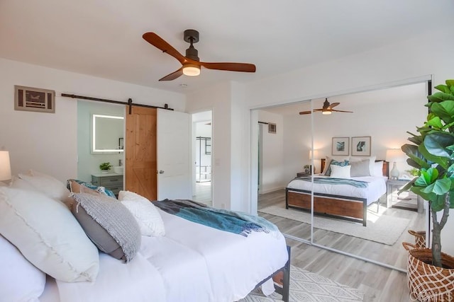 4197 Tiberon Dr, Oceanside, CA 92056 - bedroom featuring visible vents, ceiling fan, light wood-style floors, a closet, and a barn door