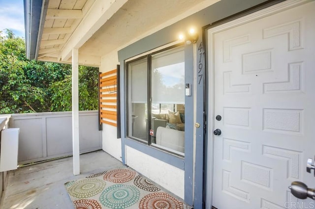 entrance to property featuring covered porch