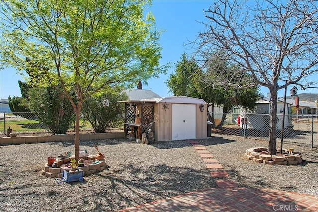 view of yard with an outbuilding, a storage shed, and a fenced backyard