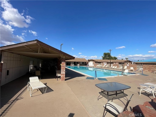 community pool with a patio area