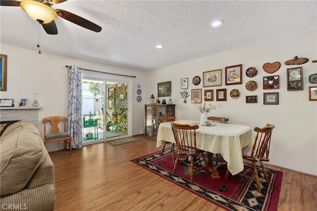 dining room with recessed lighting, a textured ceiling, a ceiling fan, and wood finished floors