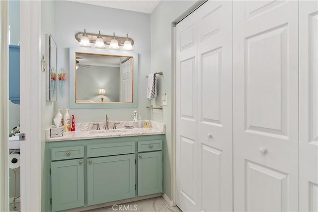 bathroom featuring a closet, marble finish floor, and vanity