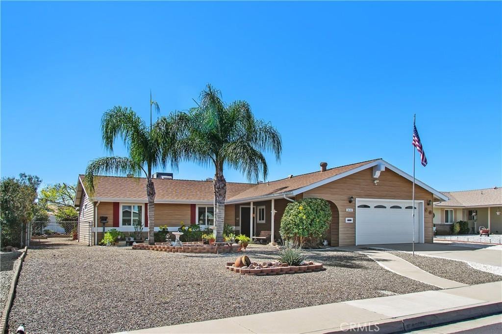 ranch-style house with a garage and driveway