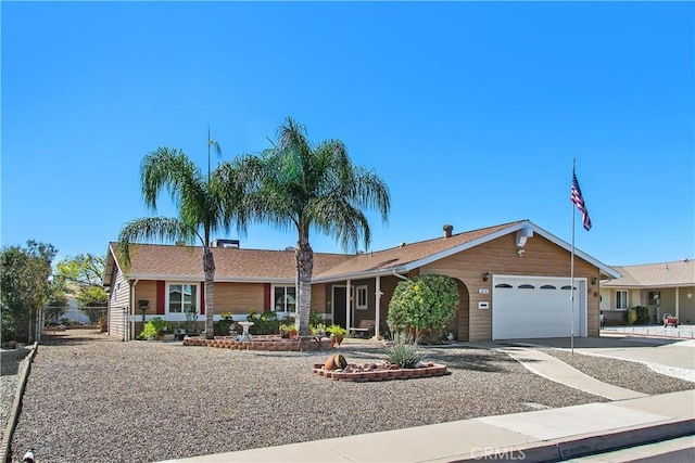 ranch-style house with a garage and driveway