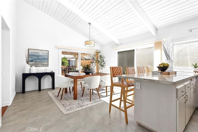 interior space featuring beam ceiling, baseboards, concrete flooring, and high vaulted ceiling