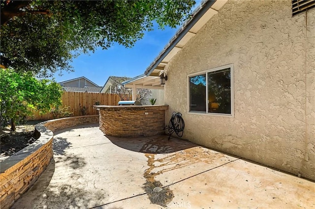 view of patio featuring fence