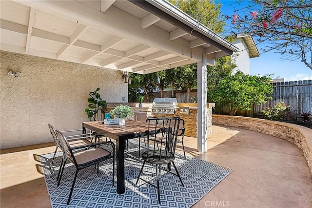 view of patio / terrace with outdoor dining space, area for grilling, fence, and a grill