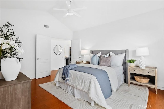 bedroom featuring visible vents, high vaulted ceiling, wood finished floors, and a ceiling fan