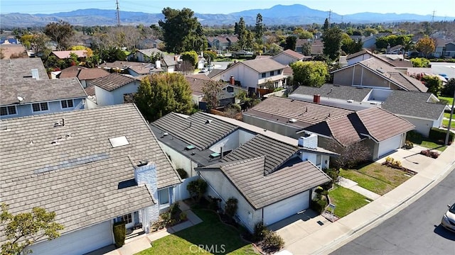 drone / aerial view featuring a residential view and a mountain view