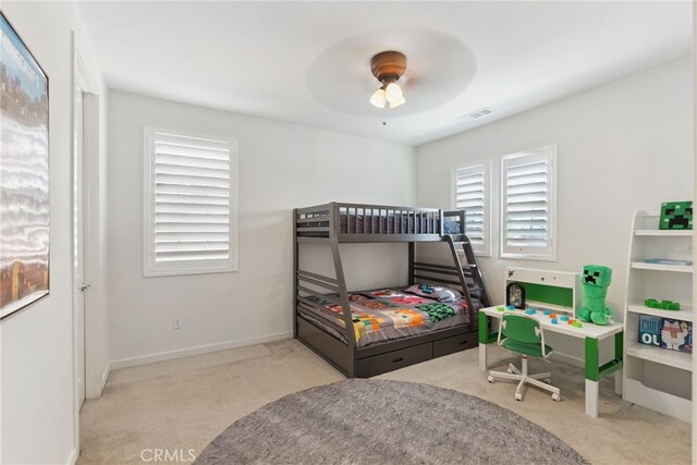 carpeted bedroom with baseboards, visible vents, and ceiling fan