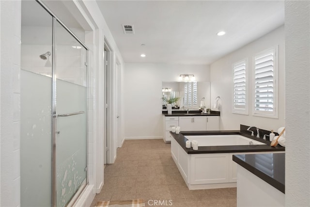 bathroom with recessed lighting, visible vents, a shower stall, and vanity