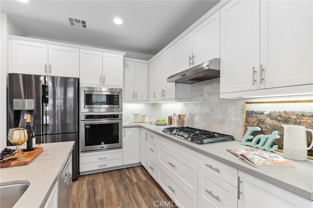 kitchen featuring under cabinet range hood, visible vents, appliances with stainless steel finishes, and light countertops