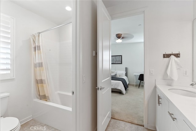 ensuite bathroom featuring tile patterned floors, shower / bath combo with shower curtain, toilet, ensuite bathroom, and vanity