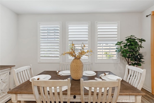 dining area with wood finished floors