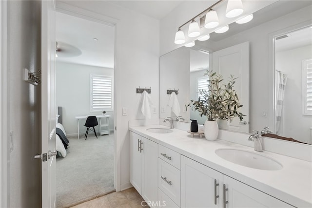 bathroom with a wealth of natural light, double vanity, and a sink