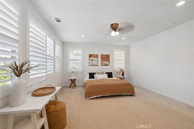 carpeted bedroom featuring a ceiling fan, recessed lighting, baseboards, and visible vents