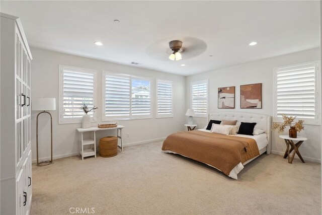 bedroom with recessed lighting, baseboards, and light carpet