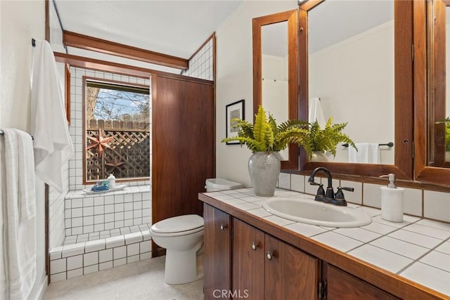 bathroom featuring vanity, toilet, and ornamental molding