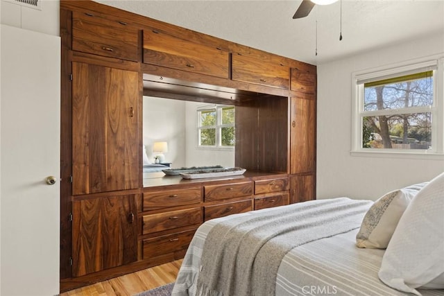 bedroom featuring light wood-style floors and ceiling fan