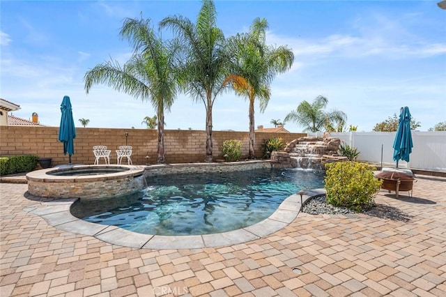 view of pool featuring a patio, a fenced backyard, and a pool with connected hot tub