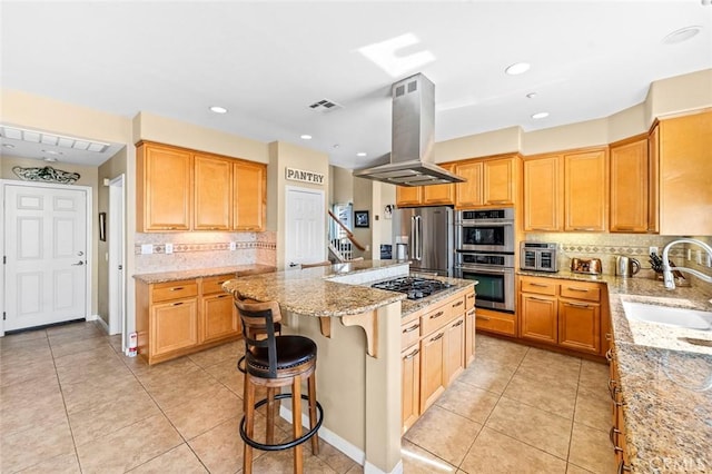 kitchen featuring visible vents, light tile patterned flooring, island exhaust hood, a sink, and appliances with stainless steel finishes