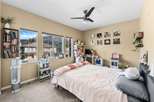 carpeted bedroom featuring a ceiling fan and baseboards