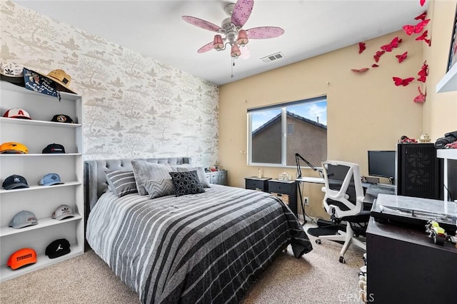 bedroom with wallpapered walls, carpet flooring, a ceiling fan, and visible vents