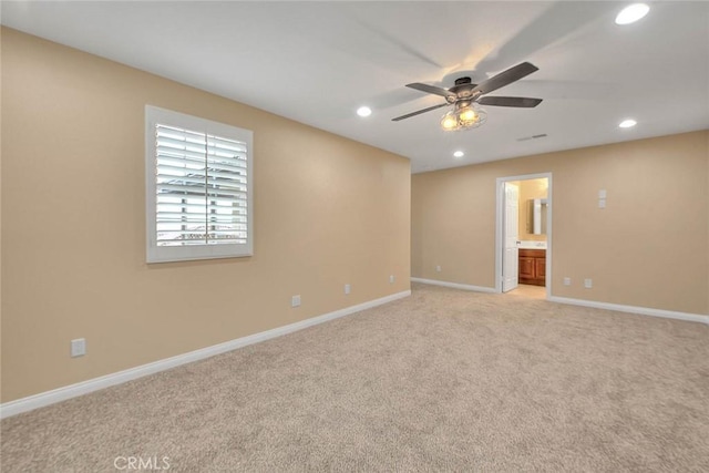 spare room with recessed lighting, baseboards, light colored carpet, and a ceiling fan