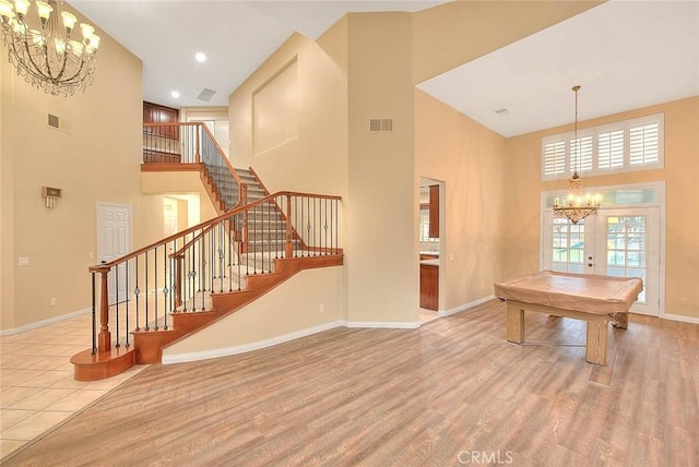 dining room with visible vents, stairway, french doors, wood finished floors, and a notable chandelier