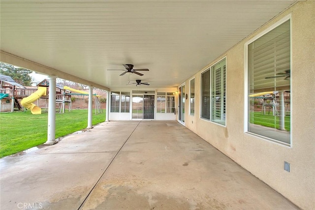 view of patio / terrace with ceiling fan and a playground