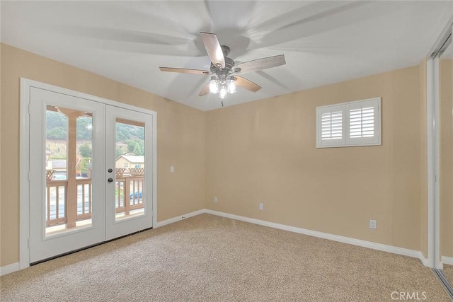 empty room featuring french doors, light colored carpet, a wealth of natural light, and baseboards