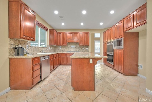 kitchen featuring light tile patterned floors, visible vents, appliances with stainless steel finishes, and a sink