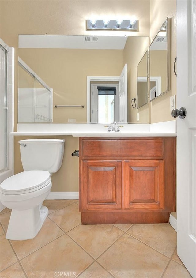 bathroom with tile patterned flooring, visible vents, a shower with door, toilet, and vanity