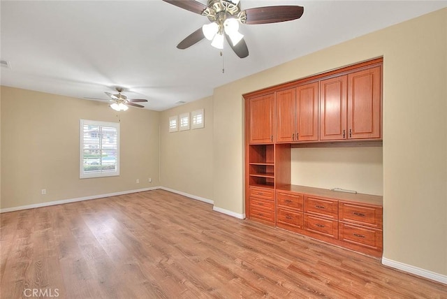 unfurnished bedroom featuring ceiling fan, baseboards, and light wood-style floors