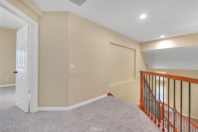 corridor with visible vents, an upstairs landing, recessed lighting, carpet floors, and baseboards