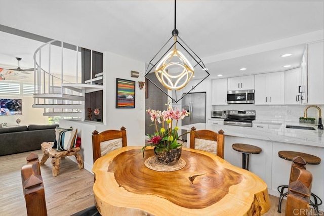 dining space featuring recessed lighting and light wood finished floors