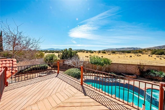 wooden terrace featuring a mountain view, a patio, a fenced in pool, and a fenced backyard